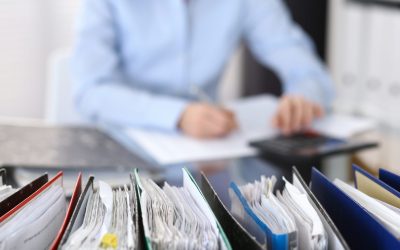Binders,With,Papers,Are,Waiting,To,Be,Processed,With,Businesswoman