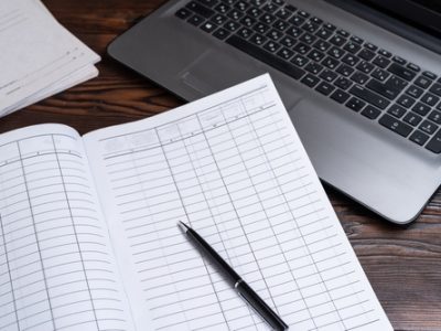 Accounting,Journal,And,Laptop.,Hand,On,Book,For,Accounting.,Keep